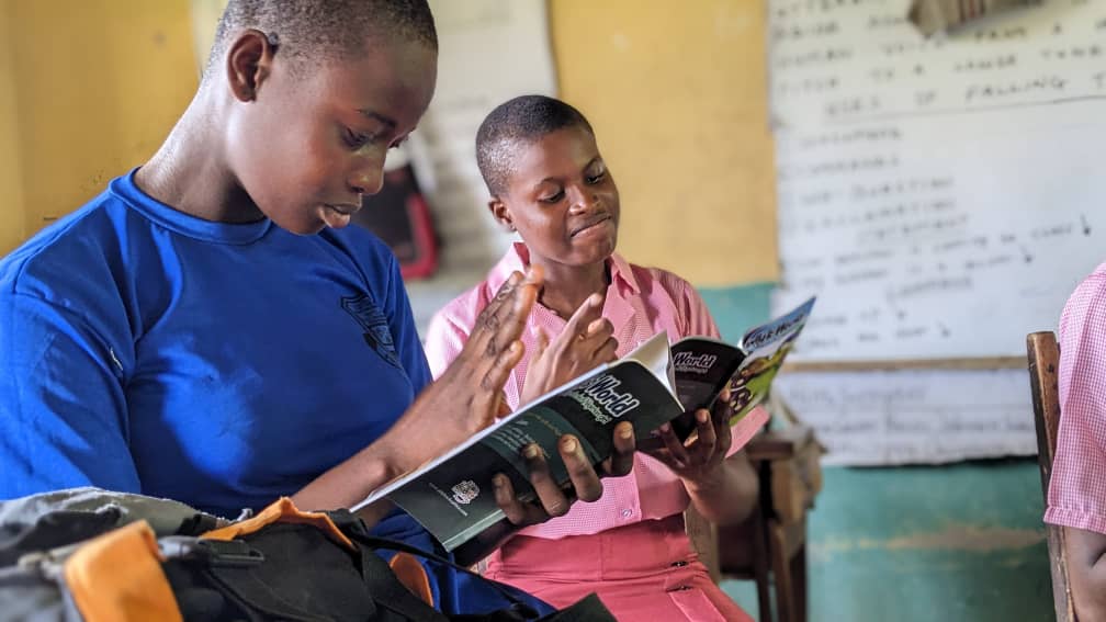 Children reading an inclusive book together in a classroom